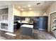 Spacious kitchen with gray cabinetry, an island, stainless appliances, and light-filled sliding glass doors at 981 Leadville Meadows Dr, Henderson, NV 89052