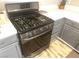 Close-up of stainless steel stove with gray cabinets and white countertop at 981 Leadville Meadows Dr, Henderson, NV 89052