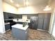 Updated kitchen features gray cabinets, stainless steel appliances, and a center island at 981 Leadville Meadows Dr, Henderson, NV 89052