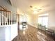 Living room with windows, wood floors, and staircase with wood trim at 981 Leadville Meadows Dr, Henderson, NV 89052