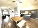 Open concept living room, dining area, and kitchen with modern appliances and wood flooring at 981 Leadville Meadows Dr, Henderson, NV 89052