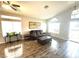 Bright living room features wood flooring, a ceiling fan, and comfortable seating arrangement at 981 Leadville Meadows Dr, Henderson, NV 89052