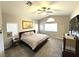 Main bedroom with a ceiling fan, a large bed, and carpet flooring at 981 Leadville Meadows Dr, Henderson, NV 89052