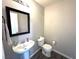 Cozy powder room features pedestal sink, framed mirror, and modern fixtures at 981 Leadville Meadows Dr, Henderson, NV 89052