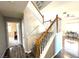 Carpeted stairs with wooden banister leading to an open second floor at 981 Leadville Meadows Dr, Henderson, NV 89052