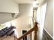 View of the staircase with wooden railing, hardwood floors, and living room area at 981 Leadville Meadows Dr, Henderson, NV 89052