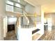 Staircase with wooden banister, carpet on the stairs, and a large open space at 981 Leadville Meadows Dr, Henderson, NV 89052