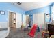 Bright bedroom featuring blue accent wall, white trim, carpet flooring, and play area at 10126 Cliff Dwellings Ave, Las Vegas, NV 89178