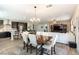 Open dining area with view into living room and modern kitchen with island at 10126 Cliff Dwellings Ave, Las Vegas, NV 89178