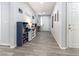 Bright hallway with wood flooring and neutral walls, leading to various rooms at 10126 Cliff Dwellings Ave, Las Vegas, NV 89178