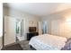 Bright bedroom featuring neutral walls, ensuite bathroom, a television, and carpet flooring at 10126 Cliff Dwellings Ave, Las Vegas, NV 89178