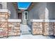 Inviting gated entryway with stone pillars leading to the front door at 10410 Charlottsville Ct, Las Vegas, NV 89149