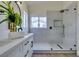 This bathroom showcases a stylish vanity and walk-in shower with modern fixtures and bright natural light at 10976 Salernes St, Las Vegas, NV 89141