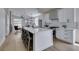 Open kitchen with long island, sleek countertops, stainless steel appliances and a view into the adjacent living space at 10976 Salernes St, Las Vegas, NV 89141