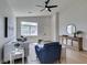 Bright living room features modern furnishings, neutral color palette, and ample natural light through a large window at 10976 Salernes St, Las Vegas, NV 89141