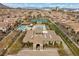 Aerial view of community pool and tennis courts, lush landscaping, and well-maintained amenities at 11322 Corsica Mist Ave, Las Vegas, NV 89135