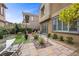 The backyard features artificial turf, and a stone patio with an outdoor dining set at 11322 Corsica Mist Ave, Las Vegas, NV 89135