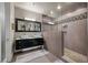 A modern bathroom with a double vanity, a glass shower enclosure, and contemporary fixtures at 11322 Corsica Mist Ave, Las Vegas, NV 89135