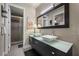 A bathroom showcasing a double vanity with vessel sinks, a glass shower enclosure, and a large mirror at 11322 Corsica Mist Ave, Las Vegas, NV 89135