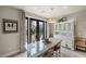 A dining room featuring glass doors with decorative trim, an elegant chandelier, and stylish decor at 11322 Corsica Mist Ave, Las Vegas, NV 89135