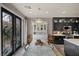 An elegant dining room featuring black-trimmed glass doors and stylish lighting at 11322 Corsica Mist Ave, Las Vegas, NV 89135
