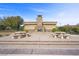 Outdoor fireplace surrounded by stone picnic tables set on a decorative concrete patio is a great common area for gathering at 11322 Corsica Mist Ave, Las Vegas, NV 89135