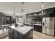 Gourmet kitchen with an island, modern stainless steel appliances, and custom cabinets at 11322 Corsica Mist Ave, Las Vegas, NV 89135