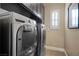 Convenient laundry room with front loading washer and dryer, plus cabinetry at 11322 Corsica Mist Ave, Las Vegas, NV 89135