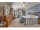 A cozy main bedroom with neutral walls, a ceiling fan, and an elegant furniture set at 11322 Corsica Mist Ave, Las Vegas, NV 89135