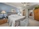 A serene main bedroom with a tray ceiling, a decorative bed frame, and an en-suite bathroom at 11322 Corsica Mist Ave, Las Vegas, NV 89135