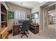 A functional office with a desk, a bookcase, and a window with wooden shutters at 11322 Corsica Mist Ave, Las Vegas, NV 89135