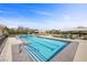 Resort-style pool with lane markers, lounge chairs, and well-maintained landscaping provides residents a relaxing community space at 11322 Corsica Mist Ave, Las Vegas, NV 89135