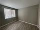 Bedroom featuring neutral walls, wood-look flooring, and a window offering natural light at 1505 Blackcombe St # 103, Las Vegas, NV 89128