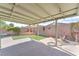 A spacious covered backyard with brick patio, green lawn, and decorative wall art for outdoor enjoyment at 2151 Babylon Mill St, Henderson, NV 89002