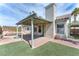 Backyard area with an outdoor fireplace, covered patio, lush grass, and swimming pool at 2151 Babylon Mill St, Henderson, NV 89002