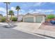 Lovely single-story home with palm trees and a spacious three-car driveway at 2151 Babylon Mill St, Henderson, NV 89002