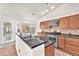 Kitchen with a large island, stainless steel appliances, wooden cabinetry, and tiled backsplash at 2151 Babylon Mill St, Henderson, NV 89002