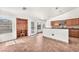 Open-concept kitchen featuring tile flooring, wood cabinetry, and a breakfast bar at 2151 Babylon Mill St, Henderson, NV 89002