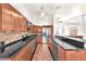 Kitchen with a large island, stainless steel appliances, wooden cabinets, and granite countertops at 2151 Babylon Mill St, Henderson, NV 89002