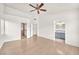 Primary bedroom with a ceiling fan, wood floors, and ensuite bathroom access at 2151 Babylon Mill St, Henderson, NV 89002