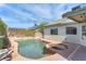 Backyard pool with a spa, patio area, lush greenery, and a clear blue sky overhead at 2151 Babylon Mill St, Henderson, NV 89002
