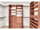 Walk-in closet with custom wood shelving and drawer organizers for optimal storage at 2151 Babylon Mill St, Henderson, NV 89002