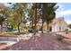 A backyard with a patio set, rock landscaping and various trees at 2246 Cassatt Dr, Henderson, NV 89074