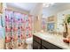 Bright bathroom features a large mirror and granite countertop vanity with tub and shower at 2246 Cassatt Dr, Henderson, NV 89074