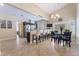 Open dining area with breakfast bar, chandelier lighting, and neutral color scheme at 2246 Cassatt Dr, Henderson, NV 89074