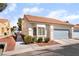 An exterior elevation showing the low maintenance landscaping, 2-car garage and the Spanish-tile roof at 2246 Cassatt Dr, Henderson, NV 89074