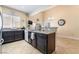 Modern kitchen with dark cabinets, granite countertops, and stainless steel appliances at 2246 Cassatt Dr, Henderson, NV 89074