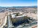 Scenic aerial view of the building, nearby cityscape, and mountains against a clear blue sky at 2405 W Serene Ave # 817, Las Vegas, NV 89123