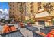 Cozy outdoor courtyard featuring an outdoor fireplace and comfortable seating under blue sky at 2405 W Serene Ave # 817, Las Vegas, NV 89123