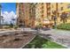 Exterior view of a courtyard area with an outdoor fireplace, seating, and well-maintained landscaping at 2405 W Serene Ave # 817, Las Vegas, NV 89123